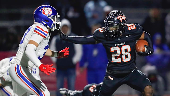 Pittsburg RB/SS Jamar Searcy (28) offers a stiff arm during the Pirates' 28-27 win over Folsom for the CIF Division 1-AA Northern California Regional title on Friday. At Pittsburg High School, 12-6-2024