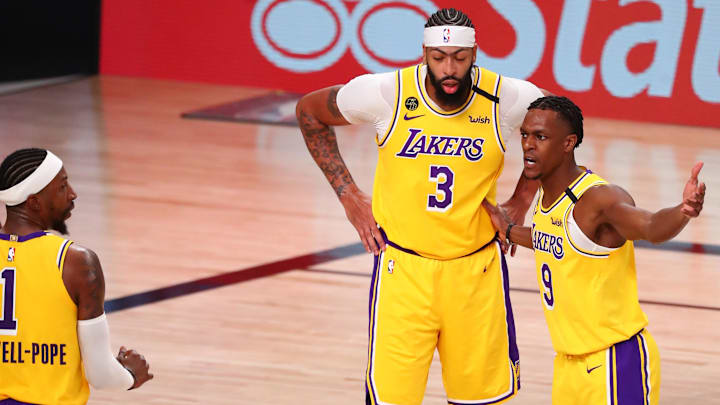 Sep 18, 2020; Lake Buena Vista, Florida, USA; Los Angeles Lakers guard Rajon Rondo (9) talks with forward Anthony Davis (center) and guard Kentavious Caldwell-Pope (left) during the second quarter in game one of the Western Conference Finals of the 2020 NBA Playoffs at AdventHealth Arena. Mandatory Credit: Kim Klement-Imagn Images
