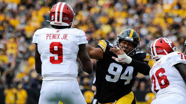 Sep 4, 2021; Iowa City, Iowa, USA; Iowa Hawkeyes defensive lineman Yahya Black (94) rushes Indiana Hoosiers quarterback Michael Penix Jr. (9) during the second quarter at Kinnick Stadium. Mandatory Credit: Jeffrey Becker-Imagn Images