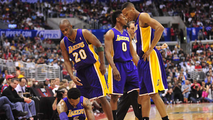 April 6, 2014; Los Angeles, CA, USA; Los Angeles Lakers guard Kent Bazemore (6) suffers an apparent injury as guard Jodie Meeks (20), forward Nick Young (0) and forward Wesley Johnson (11) help him during a stoppage in play in the first half at Staples Center. Mandatory Credit: Gary A. Vasquez-Imagn Images
April 6, 2014; Los Angeles, CA, USA; Los Angeles Lakers guard Kent Bazemore (6) suffers an apparent injury as guard Jodie Meeks (20), forward Nick Young (0) and forward Wesley Johnson (11) help him during a stoppage in play in the first half at Staples Center. Mandatory Credit: Gary A. Vasquez-Imagn Images