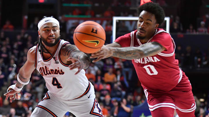 Feb 15, 2026; Champaign, Illinois, USA;  Illinois Fighting Illini guard Kylan Boswell (4) and Indiana Hoosiers guard Jasai Miles (0) vie for a loose ball during the first half at State Farm Center. Mandatory Credit: Ron Johnson-Imagn Images