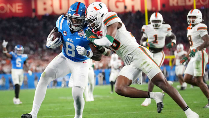 Ole Miss Rebels tight end Dae'Quan Wright (8) scores a touchdown past Miami Hurricanes defensive back Ja'Boree Antoine (16) during their Vrbo Fiesta Bowl matchup at State Farm Stadium on Jan. 8, 2026.