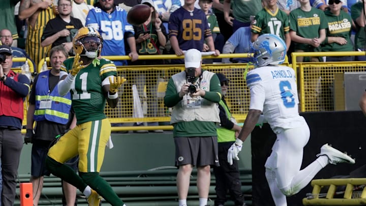 Green Bay Packers wide receiver Jayden Reed (11) catches a touchdown pass while being covered by Detroit Lions cornerback Terrion Arnold (6) during the second quarter of their game Sunday, September 7, 2025 at Lambeau Field in Green Bay, Wisconsin.