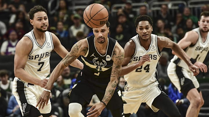 Oct 30, 2021; Milwaukee, Wisconsin, USA: Milwaukee Bucks guard George Hill (3) and San Antonio Spurs guard Bryn Forbes (7) and guard Devin Vassell (24) chase a loose ball in the second quarter at Fiserv Forum. Mandatory Credit: Benny Sieu-Imagn Images