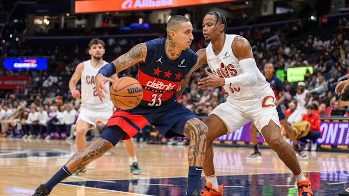 Oct 26, 2024; Washington, District of Columbia, USA; Washington Wizards forward Kyle Kuzma (33) dribbles the ball against Cleveland Cavaliers forward Isaac Okoro (35) during the second quarter at Capital One Arena. Mandatory Credit: Reggie Hildred-Imagn Images