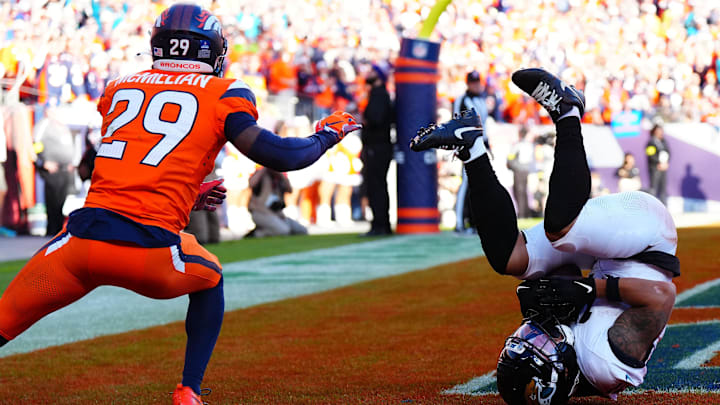 Dec 21, 2025; Denver, Colorado, USA; Jacksonville Jaguars wide receiver Parker Washington (11) makes a touchdown catch against Denver Broncos cornerback Ja'Quan McMillian (29) during the first half at Empower Field at Mile High. 