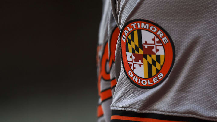 May 5, 2024; Cincinnati, Ohio, USA; The Baltimore Orioles logo on the sleeve of designated hitter Gunnar Henderson (2) as he prepares on deck during the seventh inning against the Cincinnati Reds at Great American Ball Park. Mandatory Credit: Katie Stratman-Imagn Images May 5, 2024; Cincinnati, Ohio, USA; The Baltimore Orioles logo on the sleeve of designated hitter Gunnar Henderson (2) as he prepares on deck during the seventh inning against the Cincinnati Reds at Great American Ball Park. Mandatory Credit: Katie Stratman-Imagn Images