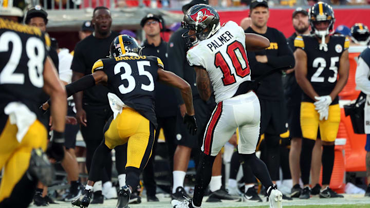 Aug 11, 2023; Tampa, Florida, USA; Tampa Bay Buccaneers wide receiver Trey Palmer (10) catches the ball as Pittsburgh Steelers cornerback Luq Barcoo (35) defends during the first half at Raymond James Stadium. Mandatory Credit: Kim Klement Neitzel-Imagn Images