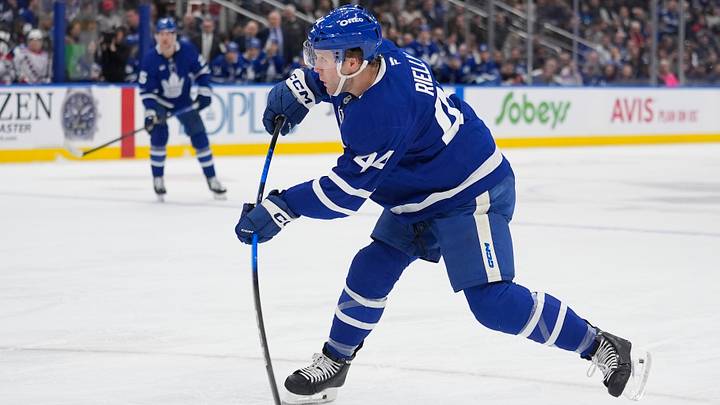 Mar 25, 2026; Toronto, Ontario, CAN; Toronto Maple Leafs defenseman Morgan Rielly (44) shoots the puck against the New York Rangers during the first period at Scotiabank Arena. Mandatory Credit: John E. Sokolowski-Imagn Images