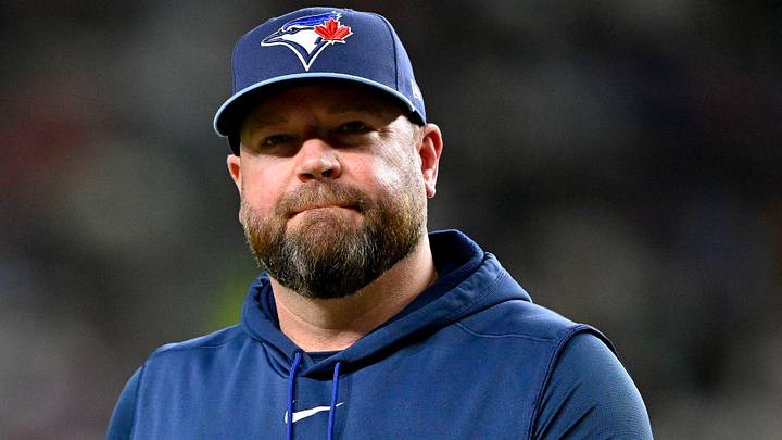 Blue Jays manager John Schneider walks back to the dugout during a game against the Rangers. Credit: Jerome Miron-Imagn