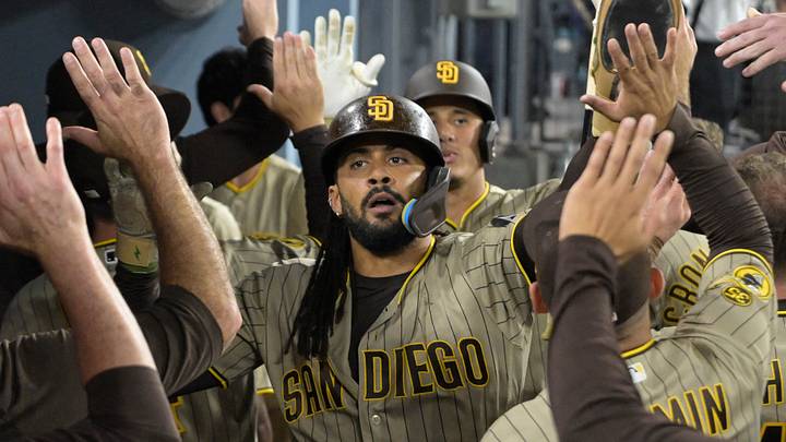 Sep 23, 2026; Los Angeles, California, USA;  San Diego Padres right fielder Fernando Tatis Jr. (23) is greeted in the dugout after scoring in the fifth inning against the Los Angeles Dodgers at Dodger Stadium. Mandatory Credit: Jayne Kamin-Oncea-Imagn Images