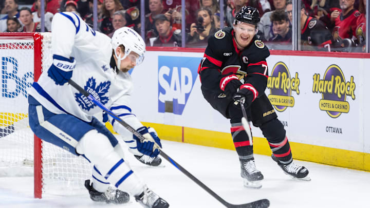 Apr 24, 2025; Ottawa, Ontario, CAN; Ottawa Senators left wing Brady Tkachuk (7) shoots the puck past Toronto Maple Leafs defenseman Simon Benoit (2) in game three of the first round of the 2025 Stanley Cup Playoffs at Canadian Tire Centre. Mandatory Credit: Marc DesRosiers-Imagn Images