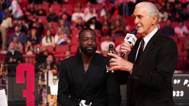 Jan 14, 2024; Miami, Florida, USA; Miami Heat president Pat Riley (R) shows former player Dwayne Wade (L) a bobble head while announcing that a statue in the likeness of Wade will be erected outside the arena in 2025, during halftime of the game between the Miami Heat and the Charlotte Hornets at Kaseya Center. Mandatory Credit: Jasen Vinlove-Imagn Images Jan 14, 2024; Miami, Florida, USA; Miami Heat president Pat Riley (R) shows former player Dwayne Wade (L) a bobble head while announcing that a statue in the likeness of Wade will be erected outside the arena in 2025, during halftime of the game between the Miami Heat and the Charlotte Hornets at Kaseya Center. Mandatory Credit: Jasen Vinlove-Imagn Images