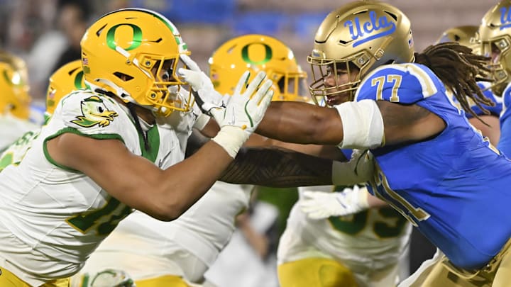 Sep 28, 2024; Pasadena, California, USA; Oregon Ducks defensive end Matayo Uiagalelei (10) and UCLA Bruins offensive lineman Jaylan Jeffers (77) battle at the line of scrimmage during the fourth quarter at Rose Bowl. Mandatory Credit: Robert Hanashiro-Imagn Images