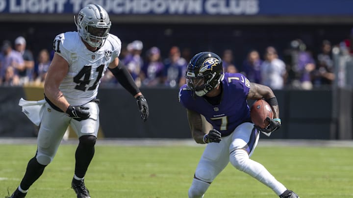 Sep 15, 2024; Baltimore, Maryland, USA;  Baltimore Ravens wide receiver Rashod Bateman (7) runs after the catch as Las Vegas Raiders linebacker Robert Spillane (41) defends during the first quarter at M&T Bank Stadium. Mandatory Credit: Tommy Gilligan-Imagn Images