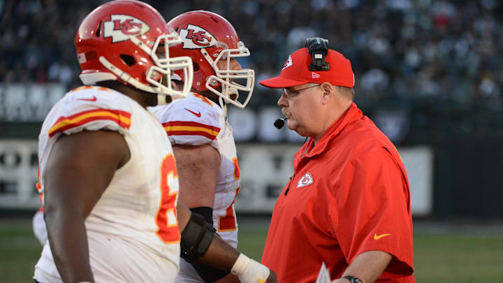 December 15, 2013; Oakland, CA, USA; Kansas City Chiefs head coach Andy Reid (right) high-fives players during the third quarter against the Oakland Raiders at O.co Coliseum. Mandatory Credit: Kyle Terada-Imagn Images