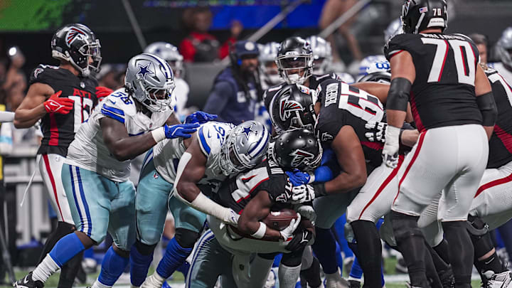 Atlanta Falcons wide receiver Ray-Ray McCloud III is tackled by Dallas Cowboys defensive tackle Osa Odighizuwa during the second half at Mercedes-Benz Stadium. 