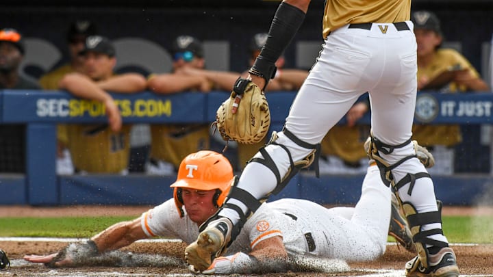 May 22 2024; Hoover, AL, USA; Tennessee base runner Dylan Dreiling slides home with a run against Vanderbilt at the Hoover Met during the SEC Tournament.