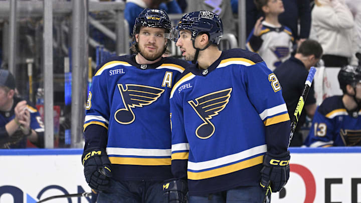Apr 1, 2024; St. Louis, Missouri, USA; St. Louis Blues center Jordan Kyrou (25) talks with center Robert Thomas (18)  during the second period of a hockey game against the Edmonton Oilers at Enterprise Center. Mandatory Credit: Jeff Le-Imagn Images