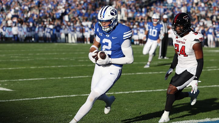 Oct 21, 2023; Provo, Utah, USA; Brigham Young Cougars wide receiver Chase Roberts (2) scores a touchdown against Texas Tech Red Raiders defensive back Malik Dunlap (24) in the first quarter at LaVell Edwards Stadium. 