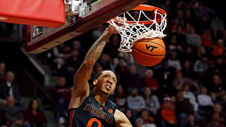 Jan 13, 2024; Blacksburg, Virginia, USA; Miami Hurricanes guard Matthew Cleveland (0) dunks the ball against Virginia Tech Hokies guard Tyler Nickel (23) during the first half at Cassell Coliseum. Mandatory Credit: Peter Casey-Imagn Images