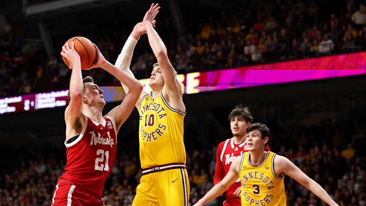 Jan 24, 2026; Minneapolis, Minnesota, USA; Nebraska Cornhuskers forward Pryce Sandfort (21) drives towards the basket as Minnesota Golden Gophers forward Cade Tyson (10) defends during the second half at Williams Arena. Mandatory Credit: Matt Krohn-Imagn Images