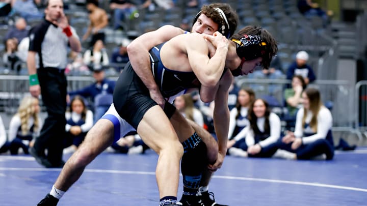 Bixby's Gage Walker (left) gets behind Edmond North's Garrison Sartain (right) during the 6A State Championship Team Wrestling Dual between Edmond North and Bixby at the Stride Bank Center in Enid, Okla., on Friday, Feb. 9, 2024.