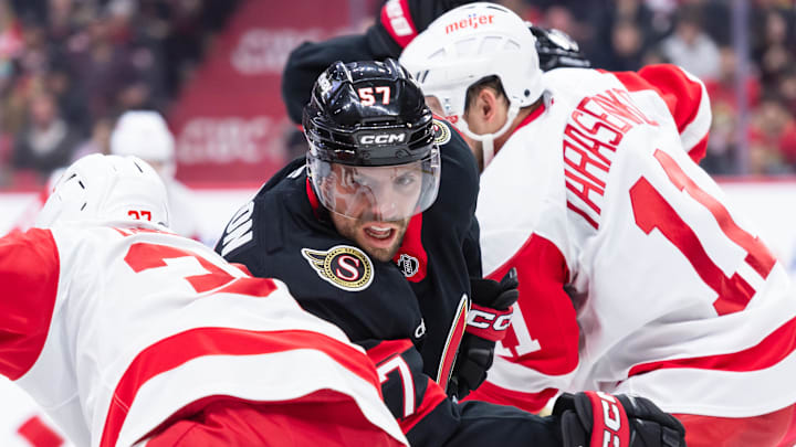Mar 10, 2025; Ottawa, Ontario, CAN; Ottawa Senators left wing David Perron (57) battles with Detroit Red Wings left wing J.T. Compher (37) and right wing Vladimir Tarasenko (11) in the first period at the Canadian Tire Centre. Mandatory Credit: Marc DesRosiers-Imagn Images