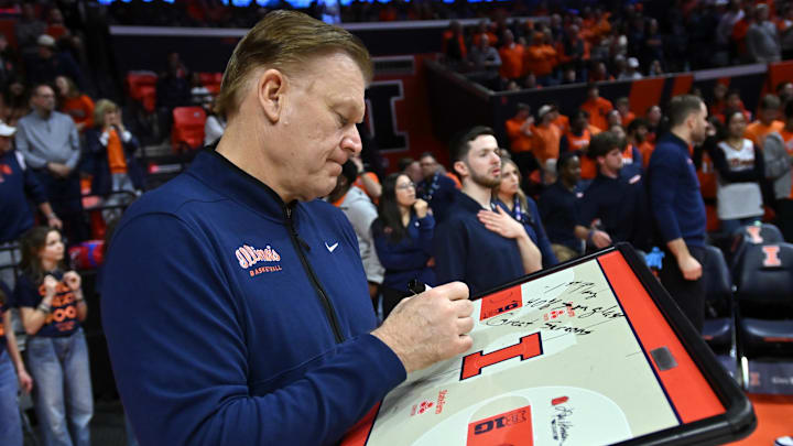 Mar 3, 2026; Champaign, Illinois, USA; Illinois Fighting Illini head coach Brad Underwood works on his game plan before the first half against the Oregon Ducks at State Farm Center. Mandatory Credit: Ron Johnson-Imagn Images Mar 3, 2026; Champaign, Illinois, USA; Illinois Fighting Illini head coach Brad Underwood works on his game plan before the first half against the Oregon Ducks at State Farm Center. Mandatory Credit: Ron Johnson-Imagn Images