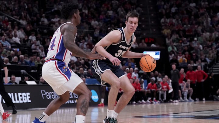 Mar 21, 2024; Salt Lake City, UT, USA; Samford Bulldogs center Riley Allenspach (35) dribbles against Kansas Jayhawks forward K.J. Adams Jr. (24) during the first half in the first round of the 2024 NCAA Tournament at Vivint Smart Home Arena-Delta Center. Mandatory Credit: Gabriel Mayberry-Imagn Images