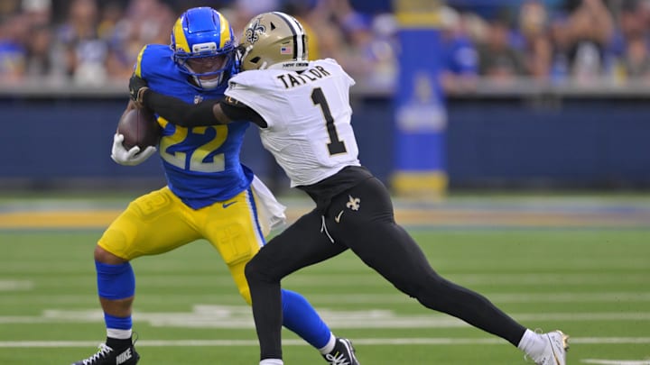 Nov 2, 2025; Inglewood, California, USA; Los Angeles Rams running back Blake Corum (22) carries the ball as New Orleans Saints cornerback Alontae Taylor (1) defends during the second half at SoFi Stadium. Mandatory Credit: Jayne Kamin-Oncea-Imagn Images