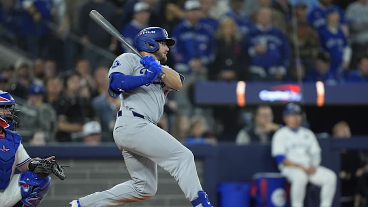 Nov 1, 2025; Toronto, Ontario, CAN; Los Angeles Dodgers third baseman Max Muncy (13) hits a single against the Toronto Blue Jays in the tenth inning during game seven of the 2025 MLB World Series at Rogers Centre. Mandatory Credit: John E. Sokolowski-Imagn Images