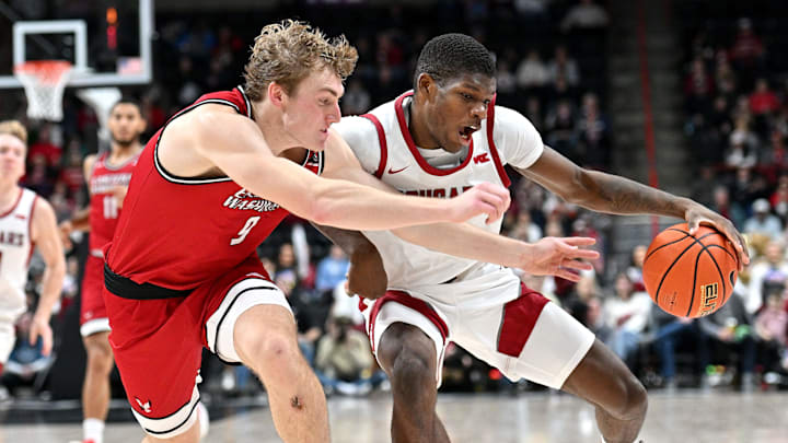 Nov 21, 2024; Spokane, Washington, USA; Washington State Cougars guard Cedric Coward (0) controls the ball against Eastern Washington Eagles guard Andrew Cook (9) in the first half at Spokane Veterans Memorial Arena. Mandatory Credit: James Snook-Imagn Images