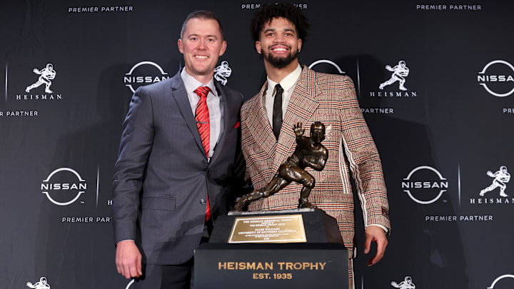Dec 10, 2022; New York, NY, USA; Southern California quarterback Caleb Williams (right) poses for photos with his head coach Lincoln Riley during a press conference in the Astor Ballroom at the New York Marriott Marquis in New York, NY, after winning the 2022 Heisman Trophy. Mandatory Credit: Brad Penner-Imagn Images