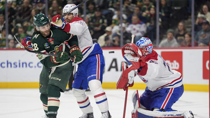 Feb 2, 2026; Saint Paul, Minnesota, USA; Minnesota Wild right wing Ryan Hartman (38) is hit by Montreal Canadiens center Joe Veleno (90) while trying to deflect a shot in the second period at Grand Casino Arena. Mandatory Credit: Matt Blewett-Imagn Images