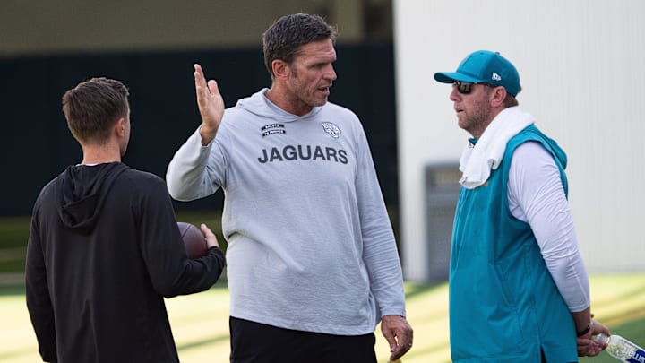 Jacksonville Jaguars General Manager James Gladstone, left and Jaguars Executive Vice President of Football Operations Tony Boselli, center, all talk with Jacksonville Jaguars Head Coach Liam Coen after the Jacksonville Jaguars’ 18th and final training camp practice at Miller Electric Center in Jacksonville, Fla. Wednesday August 20, 2025. [Doug Engle/Florida Times-Union]