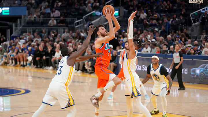 Dec 2, 2025; San Francisco, California, USA; Oklahoma City Thunder center Chet Holmgren (7) shoots the ball between Golden State Warriors forward Draymond Green (23) and guard Will Richard (3) in the third quarter at the Chase Center. Mandatory Credit: Cary Edmondson-Imagn Images Dec 2, 2025; San Francisco, California, USA; Oklahoma City Thunder center Chet Holmgren (7) shoots the ball between Golden State Warriors forward Draymond Green (23) and guard Will Richard (3) in the third quarter at the Chase Center. Mandatory Credit: Cary Edmondson-Imagn Images