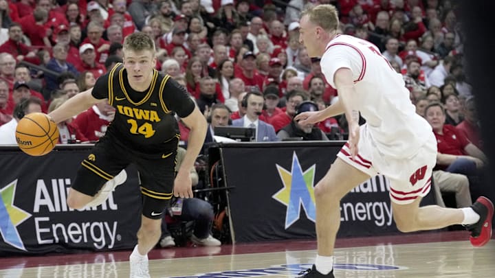Iowa guard Bennett Stirtz (14) drives on Wisconsin guard Andrew Rohde (7) during the first half of the game Sunday, February 22, 2026 at the Kohl Center in Madison, Wisconsin. Iowa guard Bennett Stirtz (14) drives on Wisconsin guard Andrew Rohde (7) during the first half of the game Sunday, February 22, 2026 at the Kohl Center in Madison, Wisconsin.