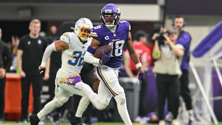 Sep 24, 2023; Minneapolis, Minnesota, USA; Minnesota Vikings wide receiver Justin Jefferson (18) scores on a touchdown pass as Los Angeles Chargers safety Alohi Gilman (32) chases from behind during the fourth quarter at U.S. Bank Stadium. Sep 24, 2023; Minneapolis, Minnesota, USA; Minnesota Vikings wide receiver Justin Jefferson (18) scores on a touchdown pass as Los Angeles Chargers safety Alohi Gilman (32) chases from behind during the fourth quarter at U.S. Bank Stadium.