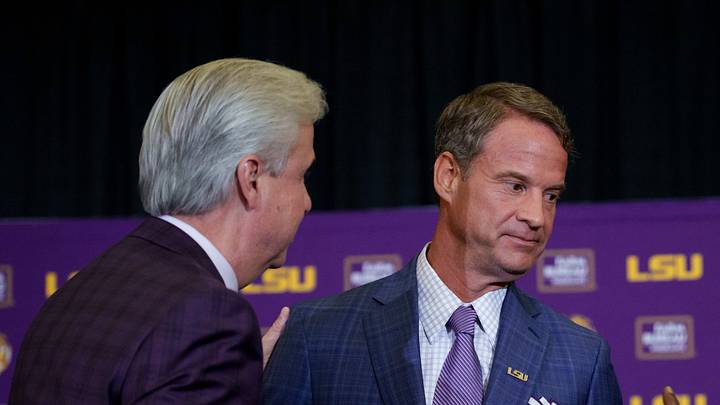 Dec 1, 2025; Baton Rouge, LA, USA; LSU president Wade Rousse, left, LSU new head coach Lane Kiffin, and LSU athletic director Verge Ausberry greet each other at South Stadium Club at Tiger Stadium. Mandatory Credit: Matthew Hinton-Imagn Images