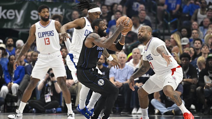 May 3, 2024; Dallas, Texas, USA; Dallas Mavericks guard Kyrie Irving (11) moves the ball past LA Clippers forward Paul George (13) and guard Terance Mann (14) and forward P.J. Tucker (17) during the first quarter during game six of the first round for the 2024 NBA playoffs at American Airlines Center. Mandatory Credit: Jerome Miron-Imagn Images