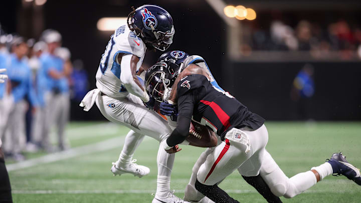 Aug 15, 2025; Atlanta, Georgia, USA; Atlanta Falcons quarterback Emory Jones (15) is tackled by Tennessee Titans cornerback Jermari Harris (30) and linebacker Amari Burney (58) in the fourth quarter at Mercedes-Benz Stadium. Mandatory Credit: Brett Davis-Imagn Images