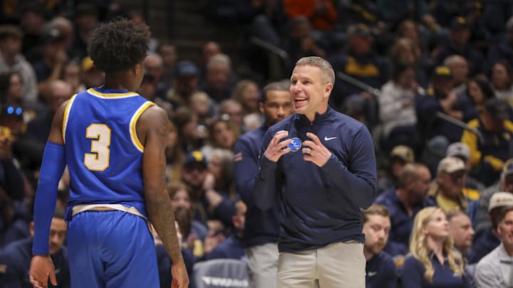 Jan 31, 2026; Morgantown, West Virginia, USA; West Virginia Mountaineers head coach Ross Hodge talks with West Virginia Mountaineers guard Honor Huff (3) during the first half against the Baylor Bears at Hope Coliseum.