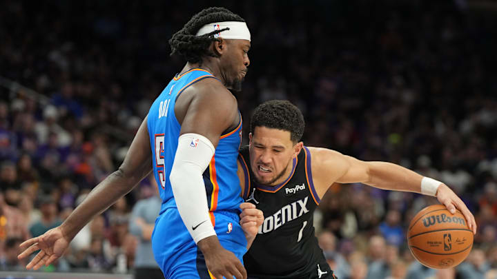 Apr 25, 2026; Phoenix, Arizona, USA; Phoenix Suns guard Devin Booker (1) drives on Oklahoma City Thunder guard Luguentz Dort (5) in the second half during game three of the first round of the 2026 NBA Playoffs at Mortgage Matchup Center. Mandatory Credit: Rick Scuteri-Imagn Images