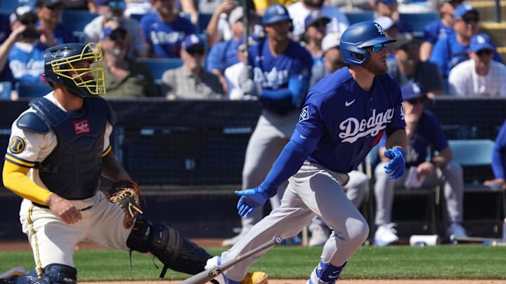 Mar 9, 2026; Phoenix, Arizona, USA; Los Angeles Dodgers third baseman Max Muncy (13) hits a single against the Milwaukee Brewers in the first inning at American Family Fields of Phoenix. Mandatory Credit: Rick Scuteri-Imagn Images