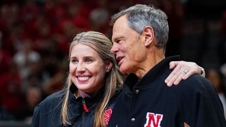 Jan 30, 2025; Lincoln, Nebraska, USA; Nebraska Cornhuskers volleyball head coach Dani Busboom Kelly and former coach John Cook embrace while being recognized during a break in the first half against the Illinois Fighting Illini at Pinnacle Bank Arena.