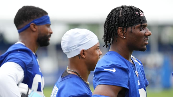 Jul 25, 2024; East Rutherford, NY, USA; New York Giants wide receiver Malik Nabers (right) watches a drill with wide receiver Wan'Dale Robinson (middle) and wide receiver Darius Slayton (left) during training camp at Quest Diagnostics Training Center.  