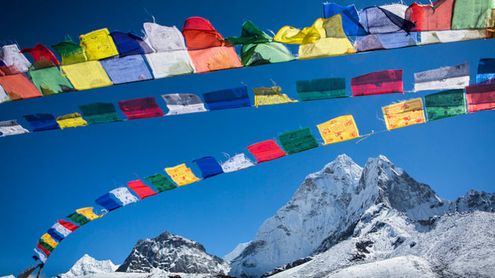 Tibetan prayer flags wave in the Himalayas.