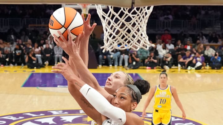 Jul 29, 2025; Los Angeles, California, USA; LA Sparks forward Cameron Brink (back) and Las Vegas Aces center A'ja Wilson (front) battle for the ball at the Crypto.com Arena. 