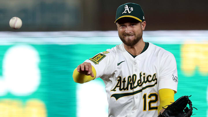 Jul 30, 2025; West Sacramento, California, USA; Athletics second baseman Max Schuemann (12) throws to first for an out against the Seattle Mariners during the eighth inning at Sutter Health Park. Mandatory Credit: Dennis Lee-Imagn Images
